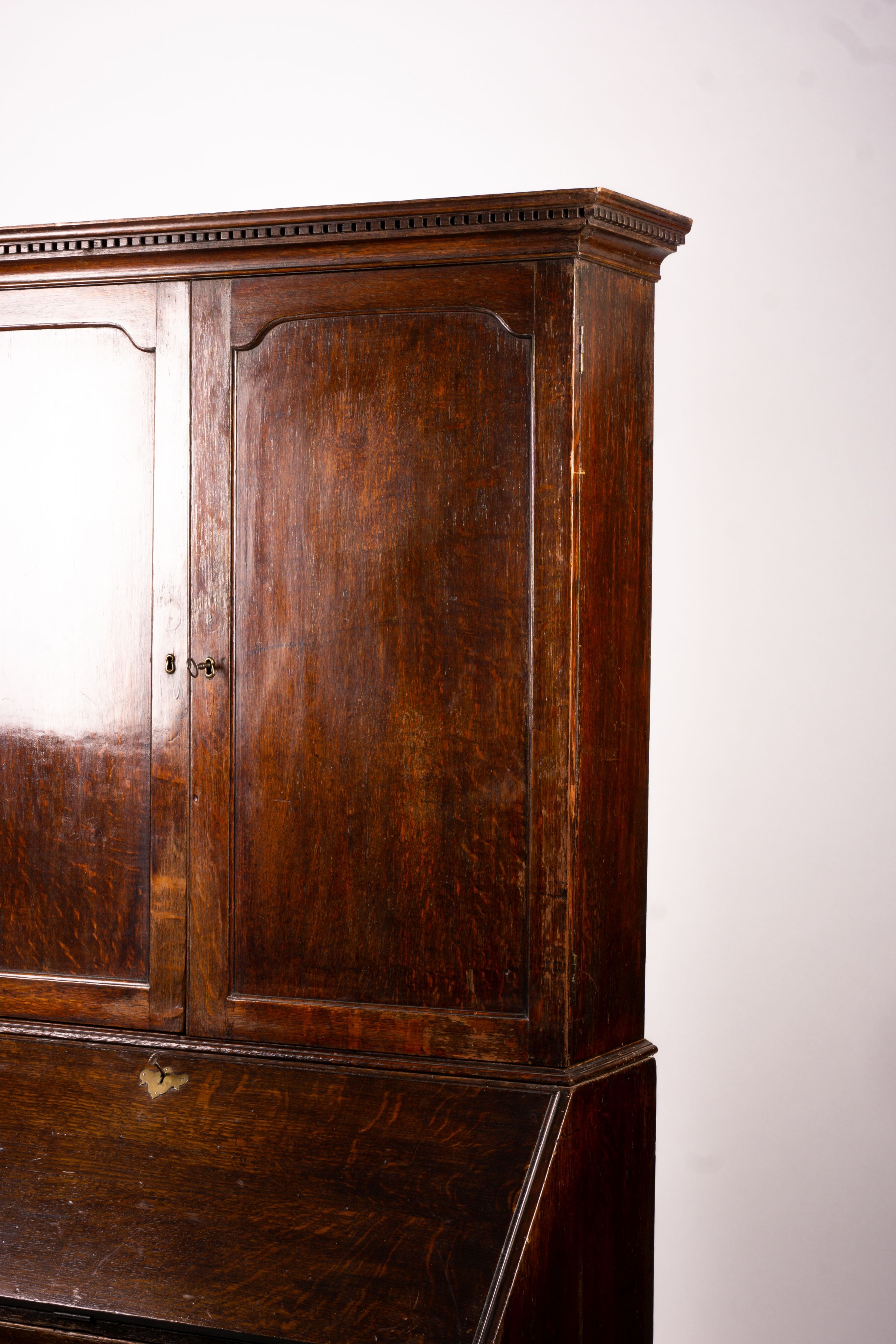 A George III oak bureau cabinet, width 108cm, depth 52cm, height 209cm